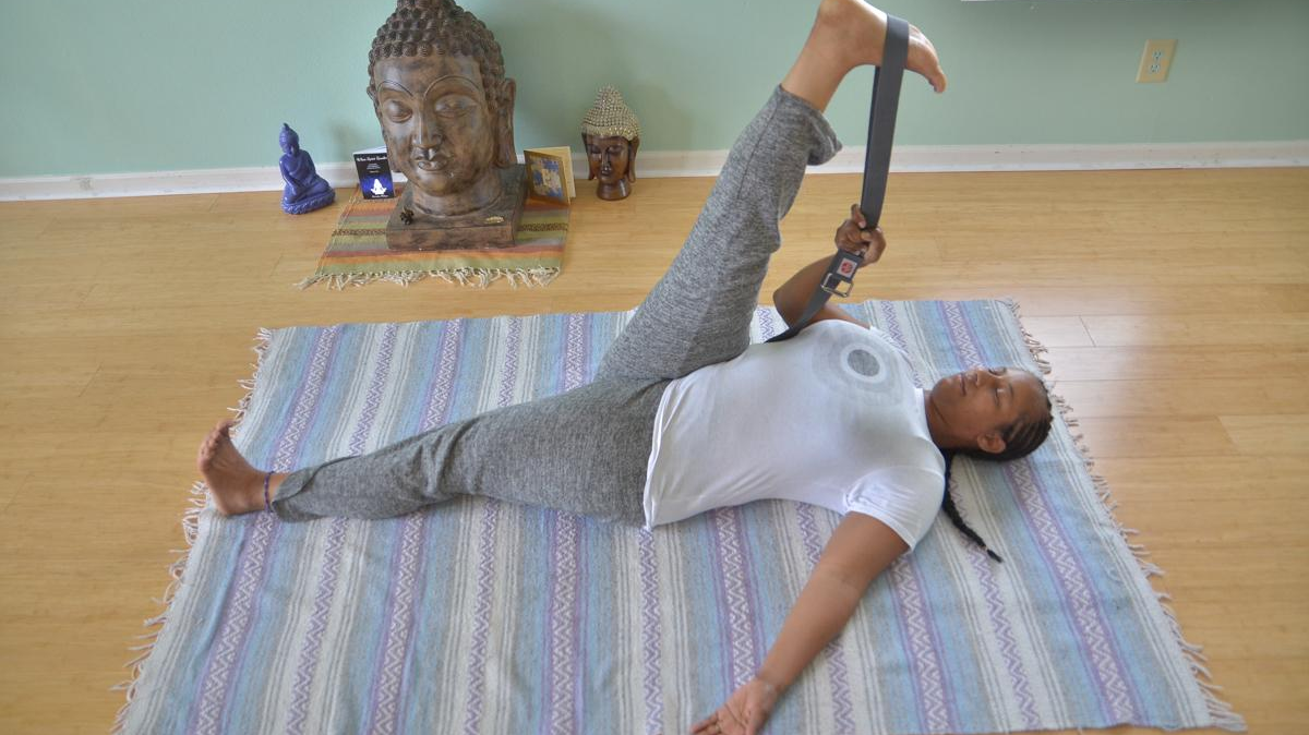 Yoga teacher Keisha Battles demonstrates a hamstring and calf stretch often practiced in yoga classes.