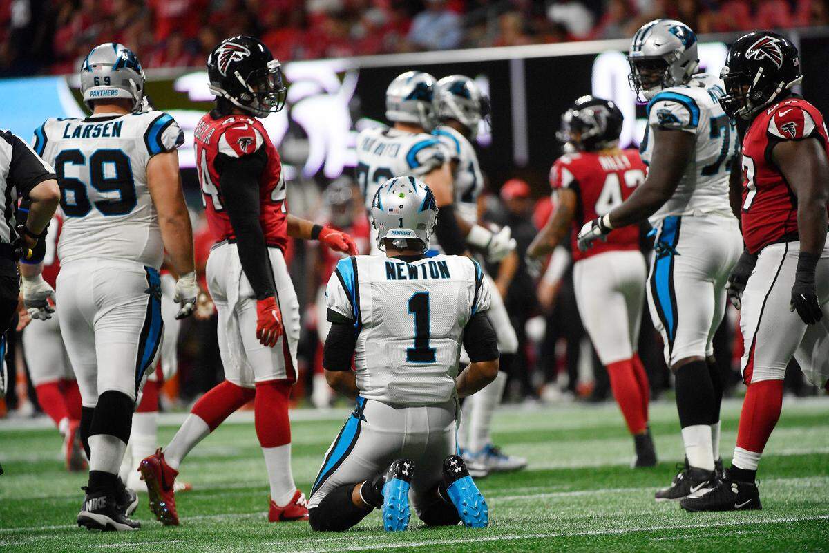 Carolina Panthers quarterback Cam Newton (1) rests on the field between plays against Atlanta. Newton threw for 335 yards and three touchdowns in the Panthers’ 31-24 loss and also rushed for 42 yards.