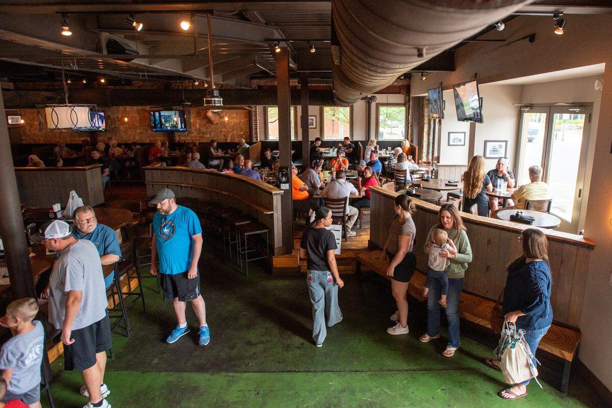 Sandy Wilson leads patrons to their table during the lunch rush at Five Points Public House in Albemarle. As a part of the Albemarle social district the restaurant is a popular location for the town residents.