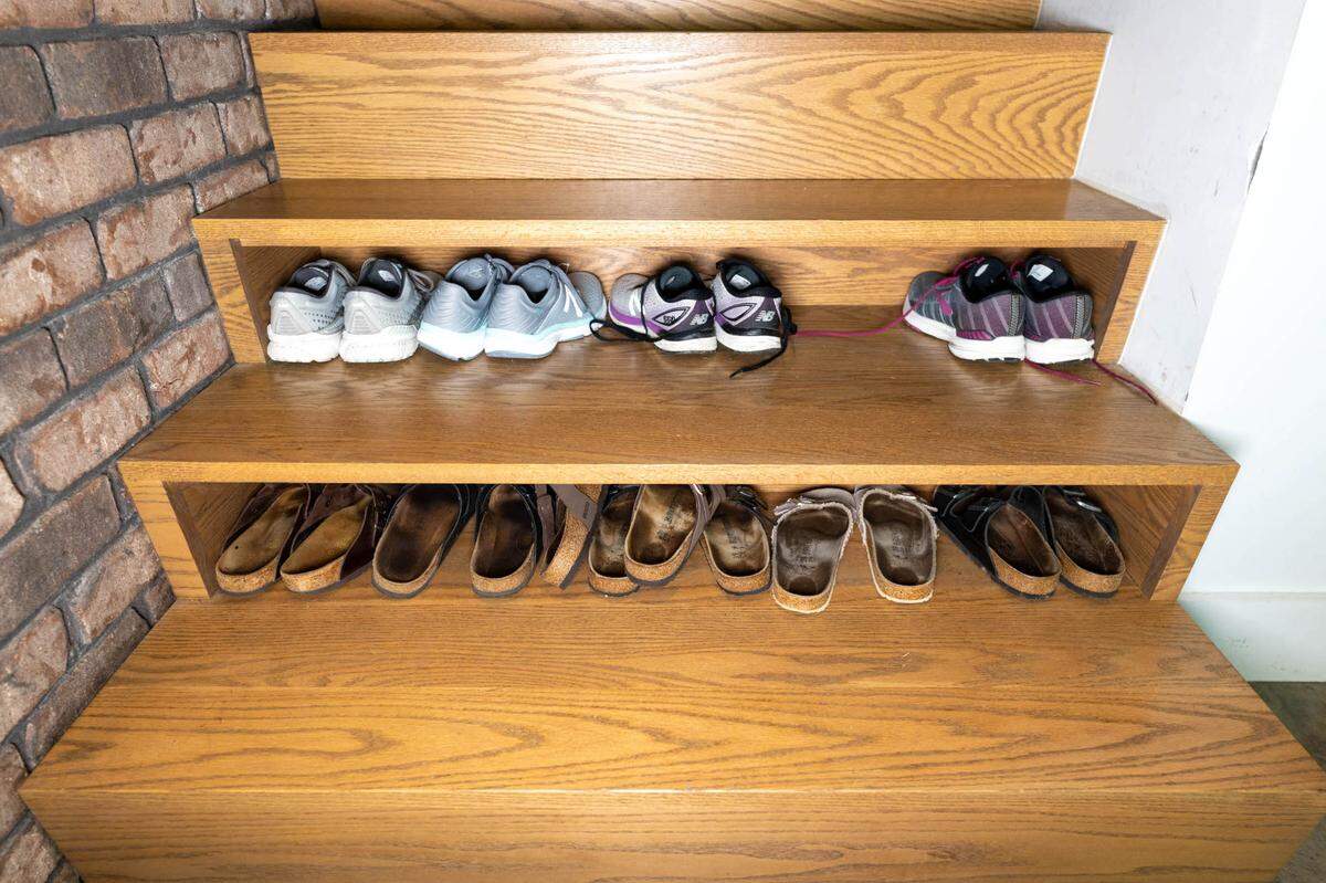 This modern design includes shoe storage space underneath the first steps inside the home.