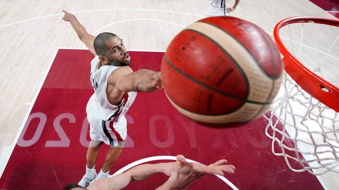 France’s Nicolas Batum, top, blocks a shot by Slovenia’s Klemen Prepelic during a men’s basketball semifinal round game at the 2020 Summer Olympics, Thursday, Aug. 5, 2021, in Saitama, Japan. (AP Photo/Charlie Neibergall, Pool)