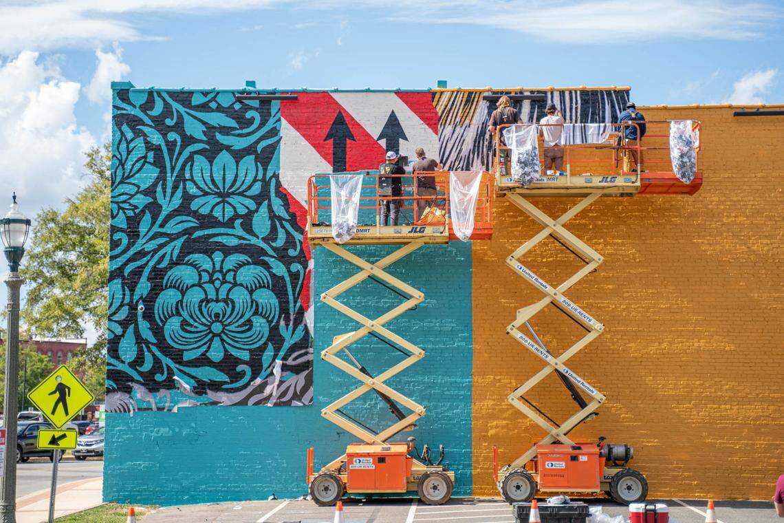 Street artist Shepard Fairey paints a mural in Old Town Rock Hill on Saturday, Oct. 16.