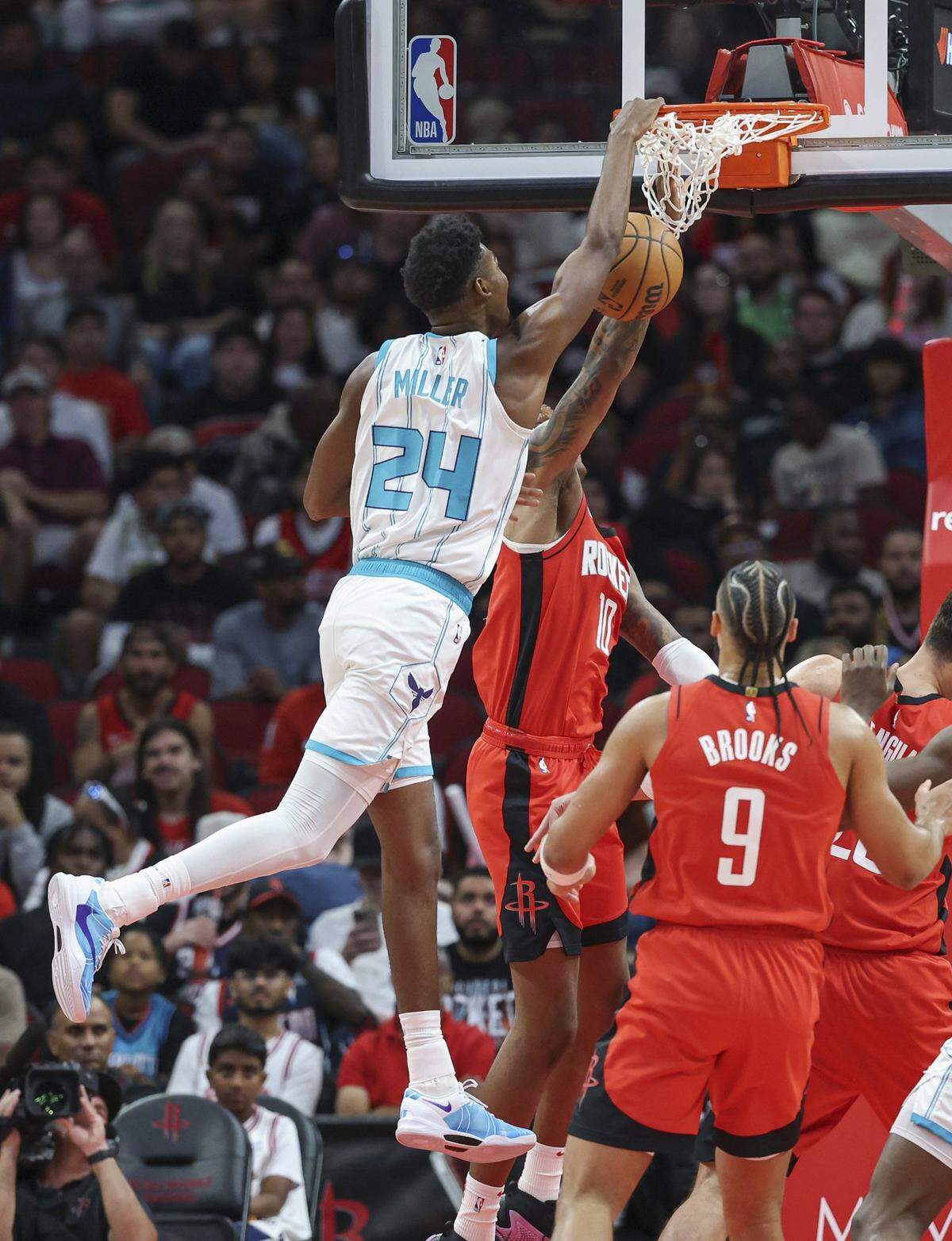 Charlotte Hornets forward Brandon Miller (24) dunks the ball over Houston Rockets forward Jabari Smith Jr. (10) during the first quarter at Toyota Center.