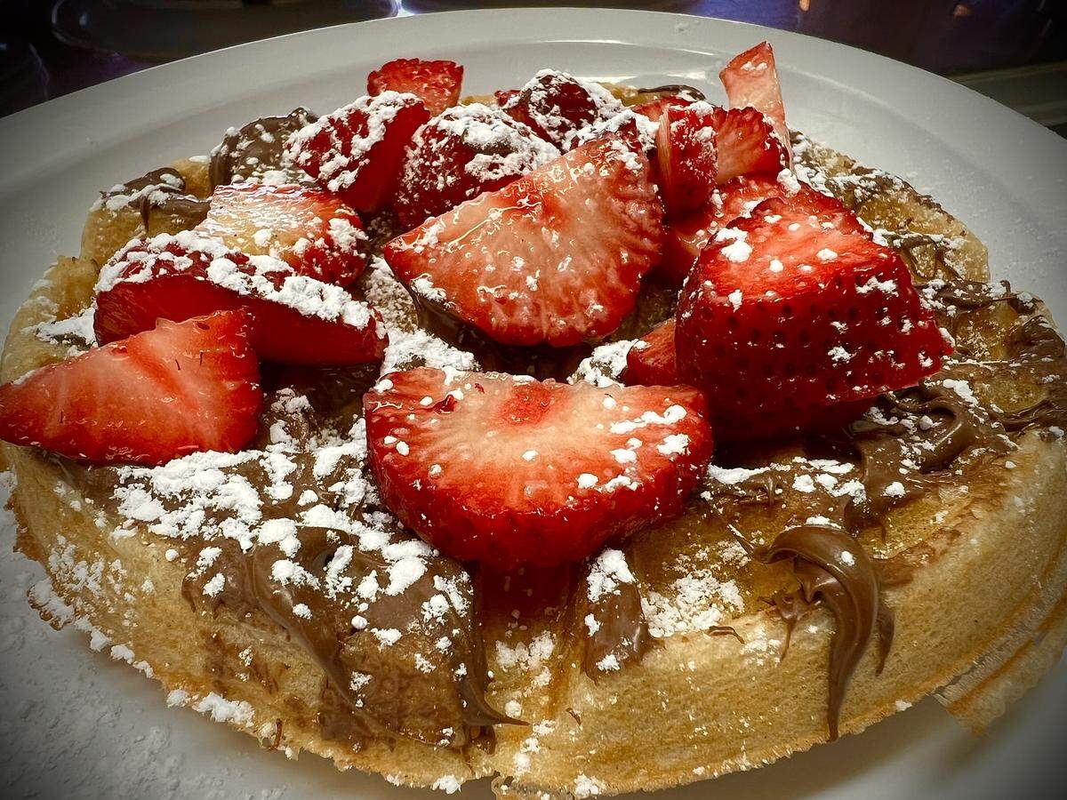 A strawberry and Nutella topped waffle.