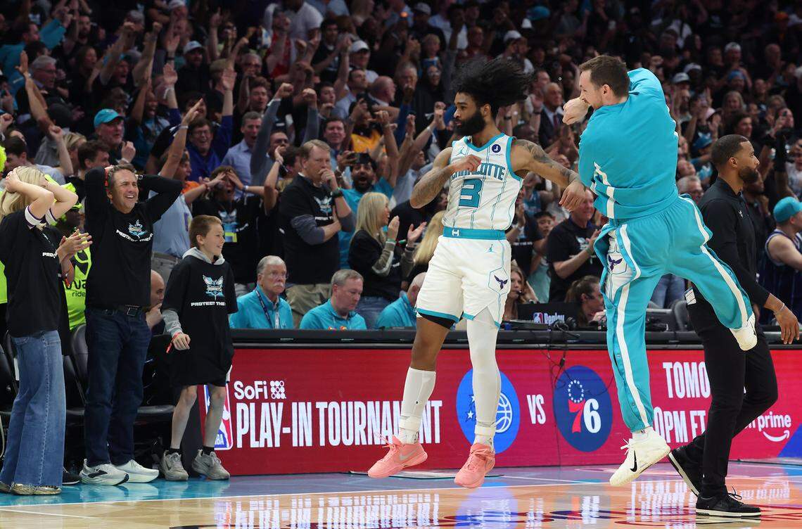 Charlotte Hornets guard Coby White, left and guard Pat Connaughton, right, celebrate a three-point basket by White as the fans react during action at Spectrum Center in Charlotte, NC on Tuesday, April 14, 2026. The Hornets defeated the Heat 127-126 in NBA Play-in-Tournament basketball game.
