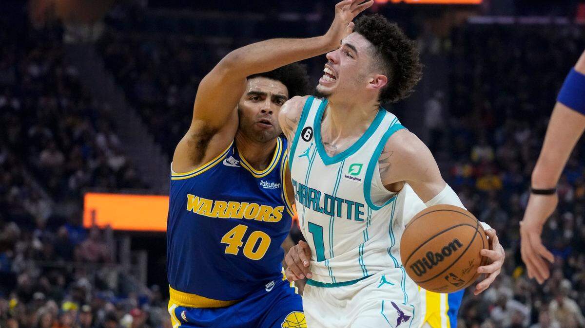 Charlotte Hornets guard LaMelo Ball (1) is fouled by Golden State Warriors forward Anthony Lamb during the first half of an NBA basketball game in San Francisco, Tuesday, Dec. 27, 2022. (AP Photo/Godofredo A. Vásquez)