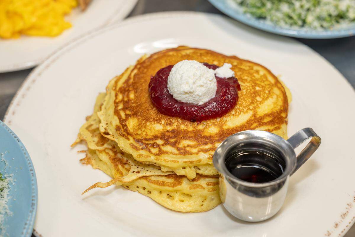 Community Matters Cafe’s dining room is popular in the mornings, with guests ordering dishes like the flapjacks with cranberry apple compote, ricotta and maple syrup, shown above.