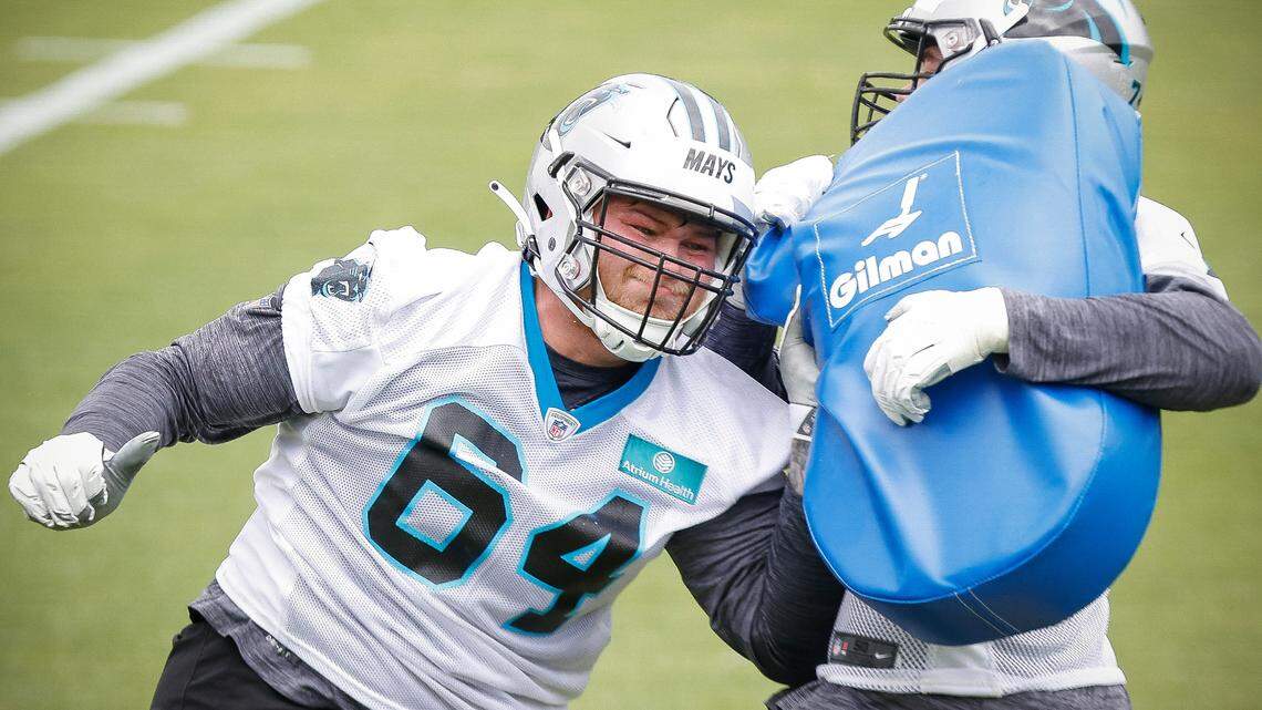 Carolina Panthers offensive lineman Cade Mays (64) runs a drill against teammate Wyatt Miller (75) during rookie minicamp at the Panthers practice field in Charlotte, N.C., Friday, May 13, 2022.