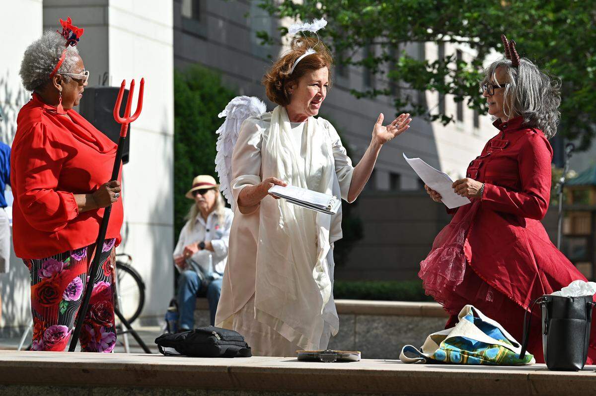 Performers from GreenFaith rehearse for a skit to be performed during a rally outside the Mecklenburg County Courthouse in Charlotte on Wednesday against Duke Energy rate hikes.
