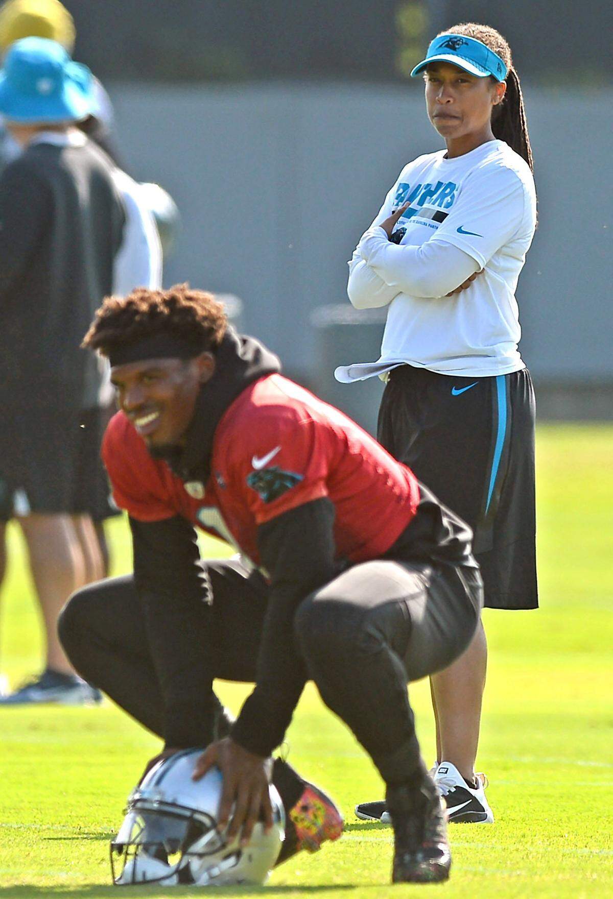 Carolina Panthers coaching intern Jennifer King, right, watches as wide receivers run through drills during the team's minicamp practice on Wednesday. King is the first female coaching intern the Panthers have ever hired. "This is for the little girls," she said Wednesday. "I want them to know that if this is what they want to do, they can do it."