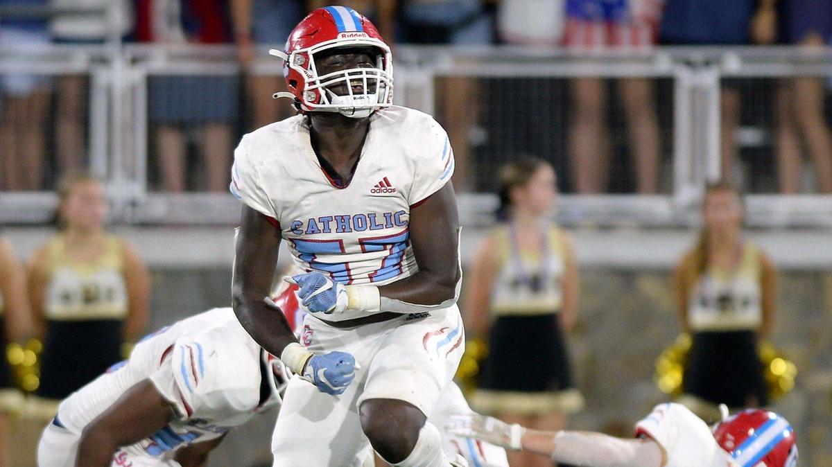 Charlotte Catholic defensive end Tyler Mills, center, celebrates a tackle of Providence High wide receiver Luke Bailey during second quarter action on Friday, September 17, 2021 at Memorial Stadium in Charlotte, NC.