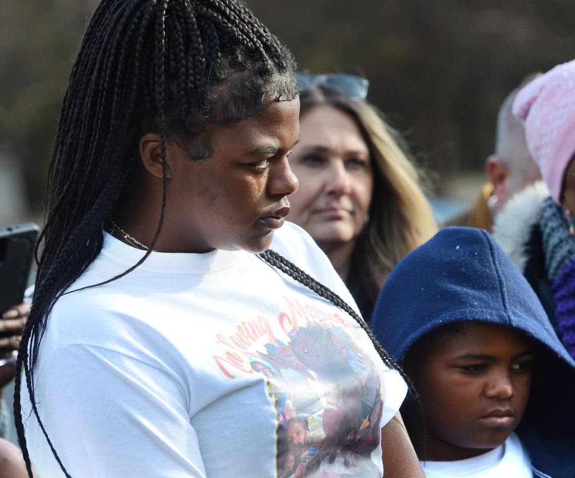 Karlotta Payton, 20, shed a tear during a brief memorial prayer for her sister Ta’haley Payton. Joshua Crawford, 10, Ta’haley’s brother was also in attendance. About 20 friends and family of Ta’haley Payton came to a grassy knoll off Charlottetowne Ave. to a release of yellow, pink and white balloons in Ta’haley’s memory near uptown Charlotte on Saturday, Dec. 14, 2024.