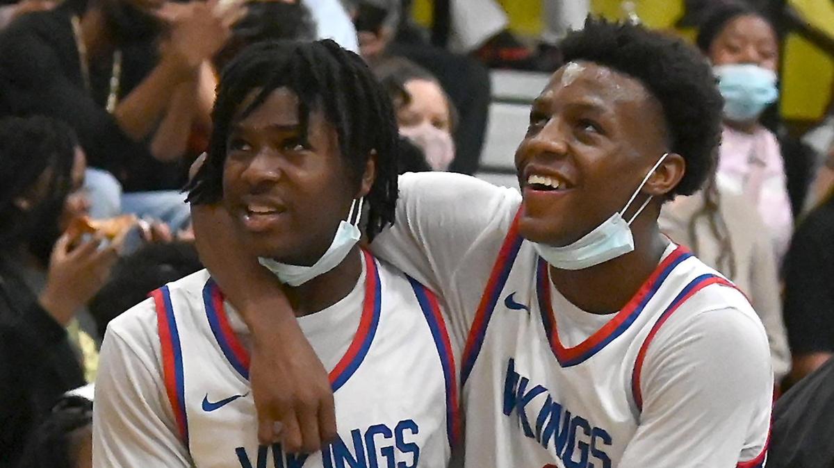 North Meck guards Jordan Crawford, left and Davion Cunningham, right, look up at the scoreboard during second half action in the Queen City boys championship game at Mallard Creek High School in Charlotte, NC on Friday, February 18, 2022. North Meck defeated Hopewell 76-52.