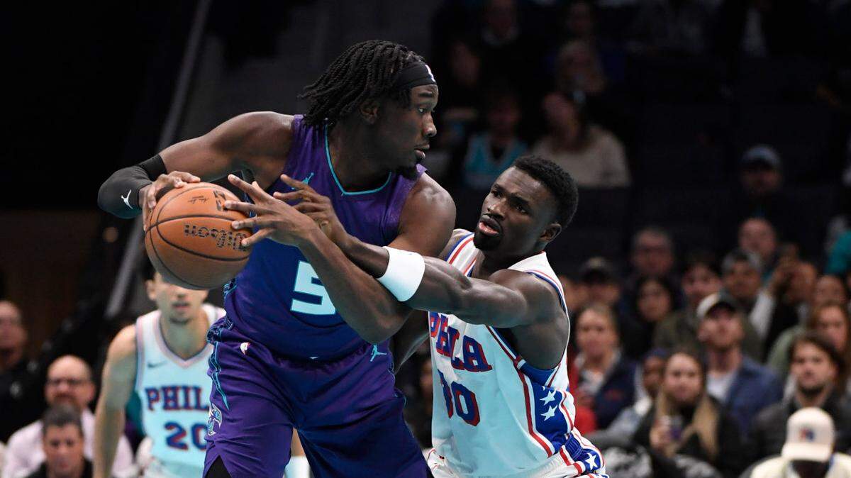 Charlotte Hornets center Mark Williams (5) handles the ball as Philadelphia 76ers center Adam Bona (30) attempts to steal it during the first half at the Spectrum Center. 