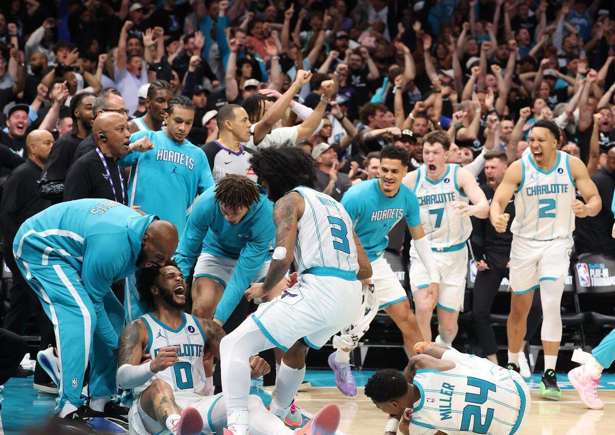 The Charlotte Hornets celebrate the team’s win over the Miami Heat on April 14. Kon Knueppel (7) is coming off the bench to join the celebration, since he didn’t play in the overtime period.