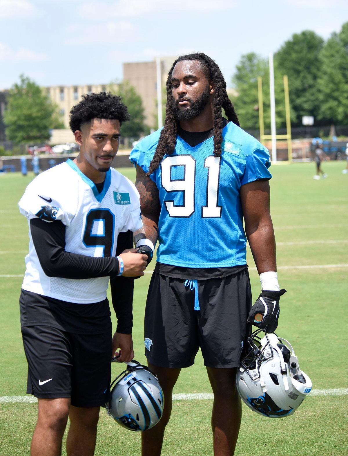 Pat Jones II, #91, a Panthers outside linebacker, talked with teammate Bryce Young, #9, Panthers quarterback after practice.The Carolina Panthers, in their second week of organized team activities, ran through drills on Tuesday, June 3, 2025 at their practice facility in uptown Charlotte.
