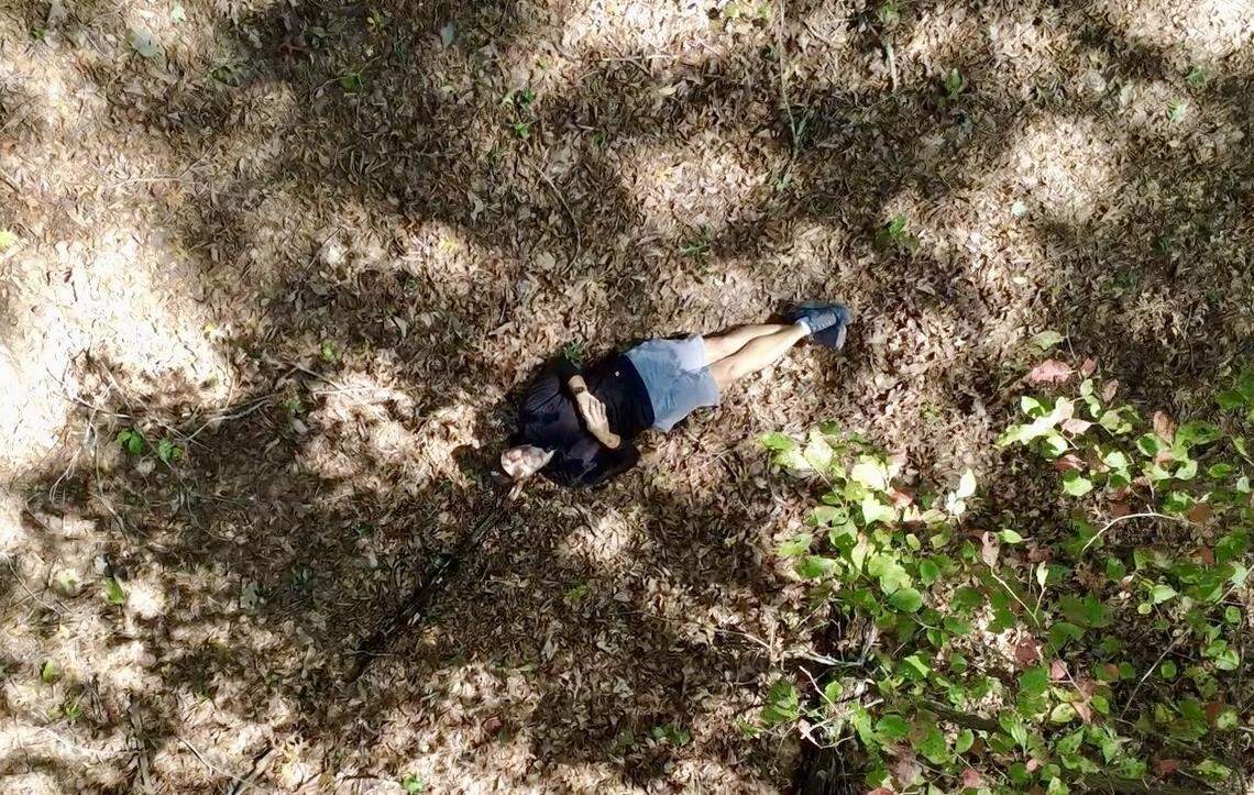 Charlotte-based coin maker, Adam Howell, lays on the Blue Ridge Mountains forest floor where the treasure is hidden.