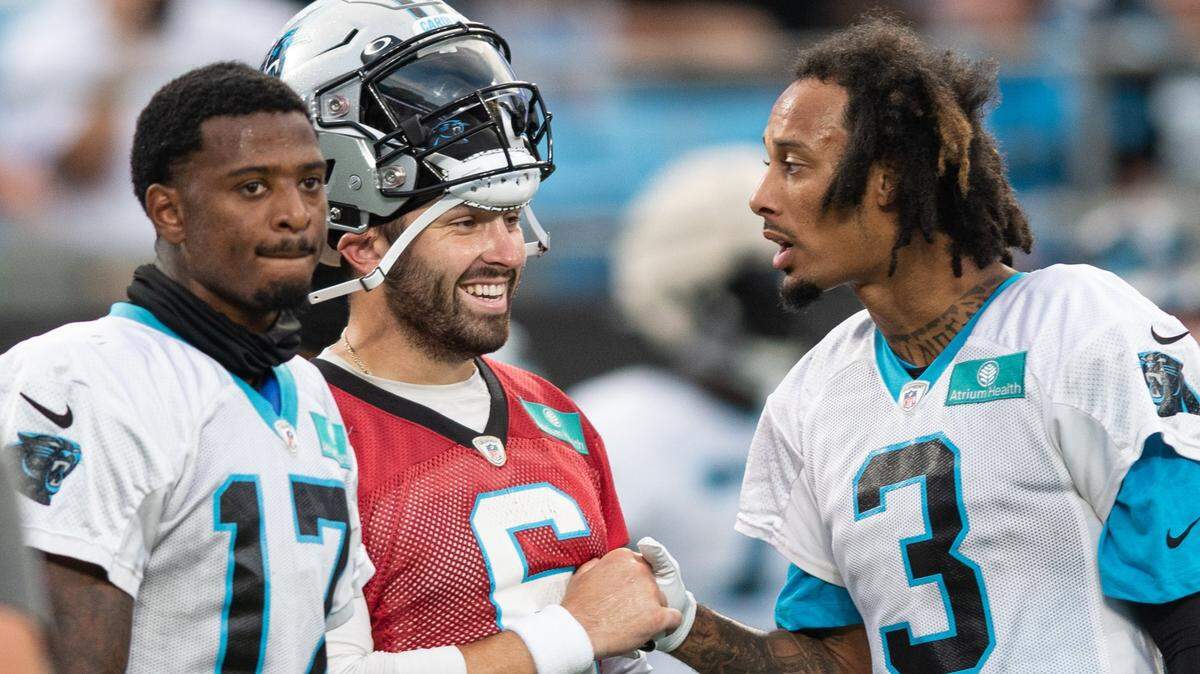 Carolina Panthers’ quarterback Baker Mayfield (6) fist-bumps wide receiver Robbie Anderson (3) during Fan Fest at Bank of America Stadium on Aug. 11.