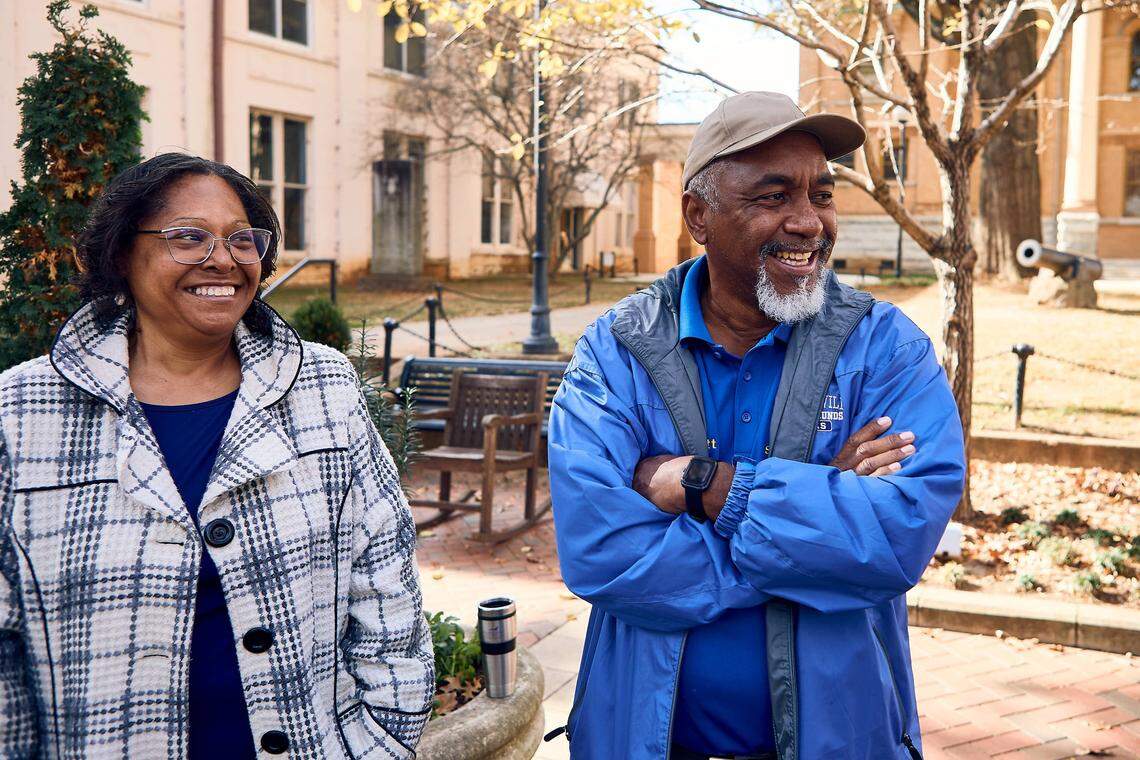 Todd Scott and Marlene Scott of the Iredell Community Remembrance Project stand in front of the 1906 statue of a Confederate soldier outside the Old Iredell County Courthouse in downtown Statesville. Project members successfully campaigned for a historical marker planned nearby to honor how Black people and white people came together to prevent further violence after the 1883 lynching of Charles Campbell.