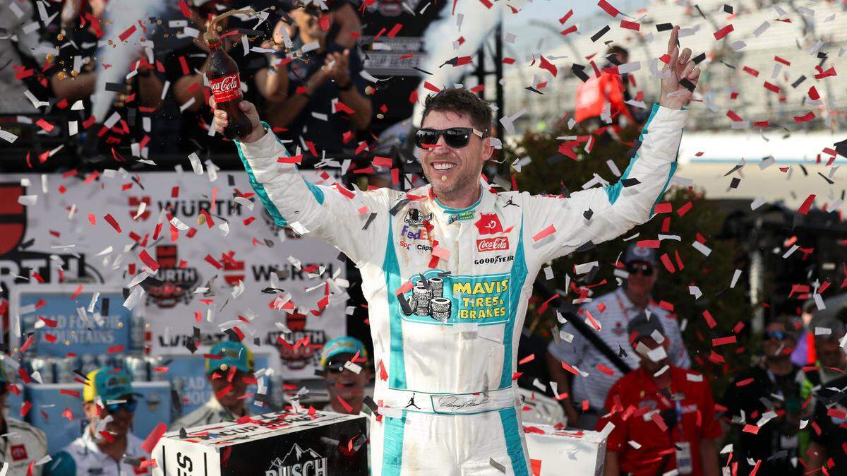 Apr 28, 2024; Dover, Delaware, USA; NASCAR Cup Series driver Denny Hamlin celebrates in victory lane after winning the Wurth 400 at Dover Motor Speedway.