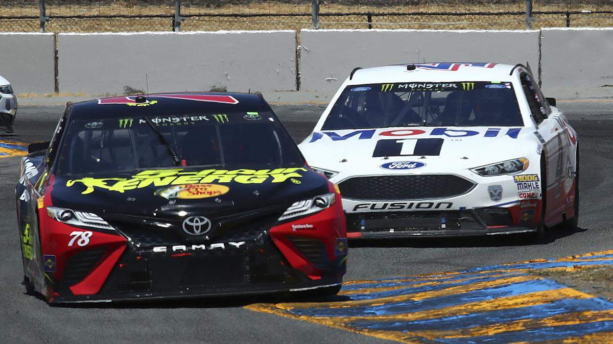 Martin Truex Jr. (78) leads Kevin Harvick (4) and Clint Bowyer, left, through a turn during a NASCAR Sprint Cup Series auto race Sunday, June 24, 2018, in Sonoma, Calif. Truex Jr. won the race, Harvick finished second and Bowyer was third.  (AP Photo/Ben Margot)
