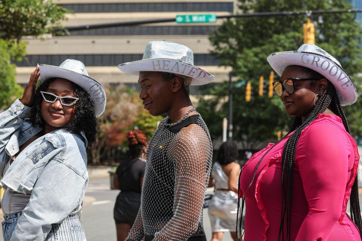 Jessica, left, William, center, and Yasmine wear hats bearing song titles from the Renaissance album. “She spent hours and hours making these hats for us,” says Jessica about her mother, who custom made the hats for the concert.