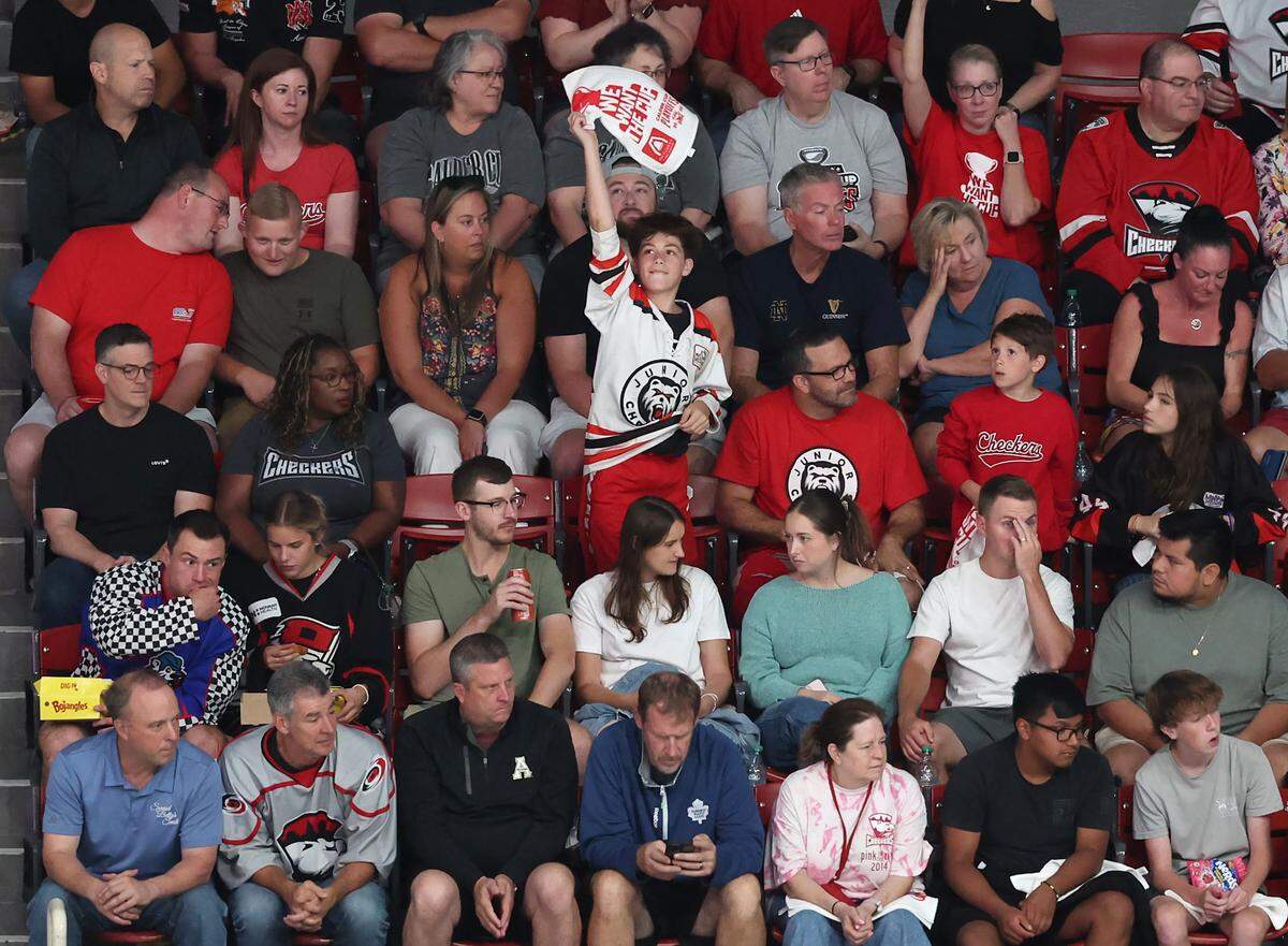 A young Charlotte Checkers fan cheers on the team during action against the Abbotsford Canucks in Monday’s Game 6 of the Calder Cup finals at Bojangles Coliseum. The Canucks defeated the Checkers 3-2 to win the Calder Cup.
