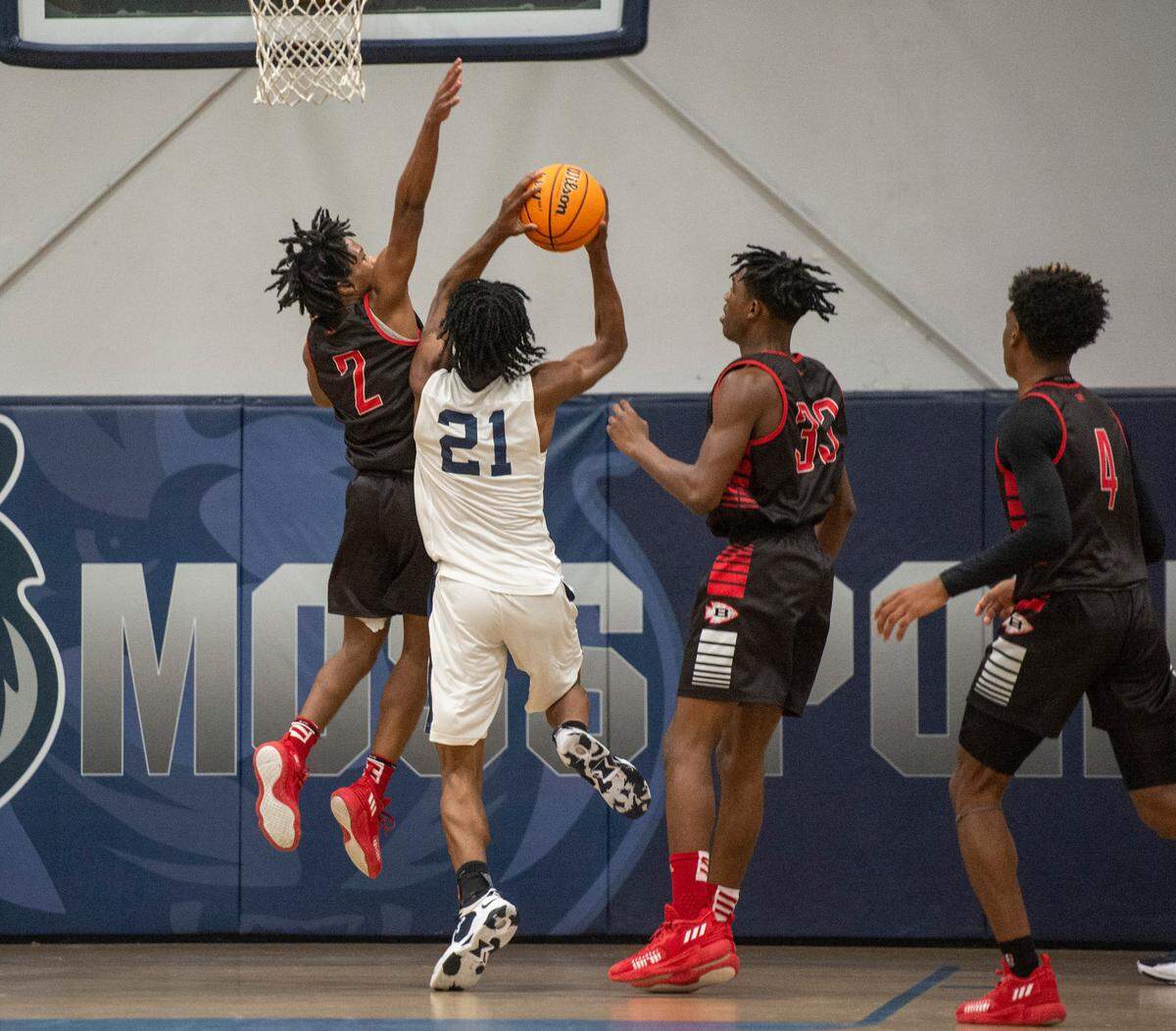 Moss Point forward Kedrick Osby gets blocked by Biloxi’s Blake Hart during a game against Biloxi at Moss Point High School in Moss Point on Tuesday, Dec. 21, 2021.