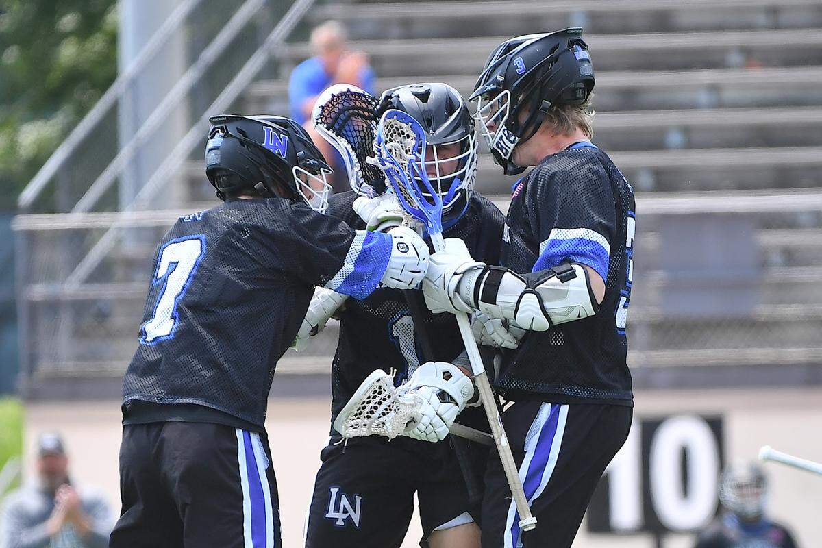 Lake Norman’s Statton Rehrer (7) , and Cannon Wigginton (3) celebrate with Brandon DeBerardinis (1) after his goal against Cardinal Gibbons in the first half. The Lake Norman Wildcats and the Cardinal Gibbons Crusaders met in the Boys NCHSAA 4A Lacrosse Championship Game in Durham, N.C. on May 31, 2025.