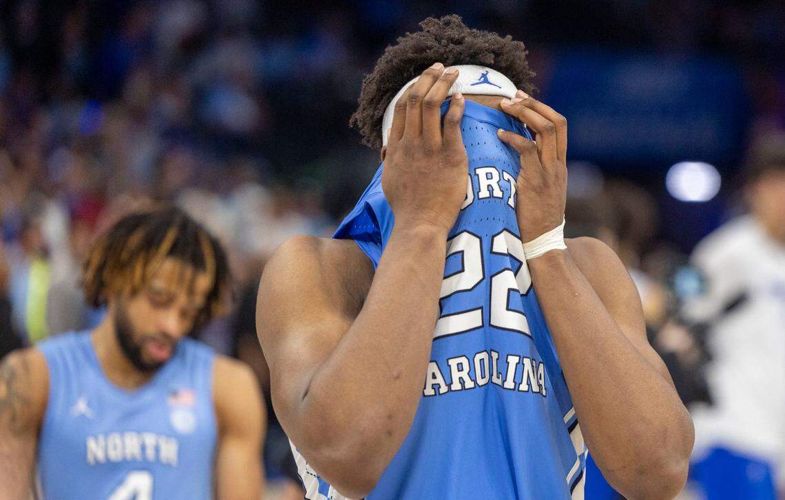 North Carolina forward Ven-Allen Lubin (22) covers his head as he leaves the court after missing a last second shot, securing a 74-71 victory for Duke on Friday, March 14, 2025 during the semifinals of the ACC Tournament at Spectrum Center in Charlotte, N.C.