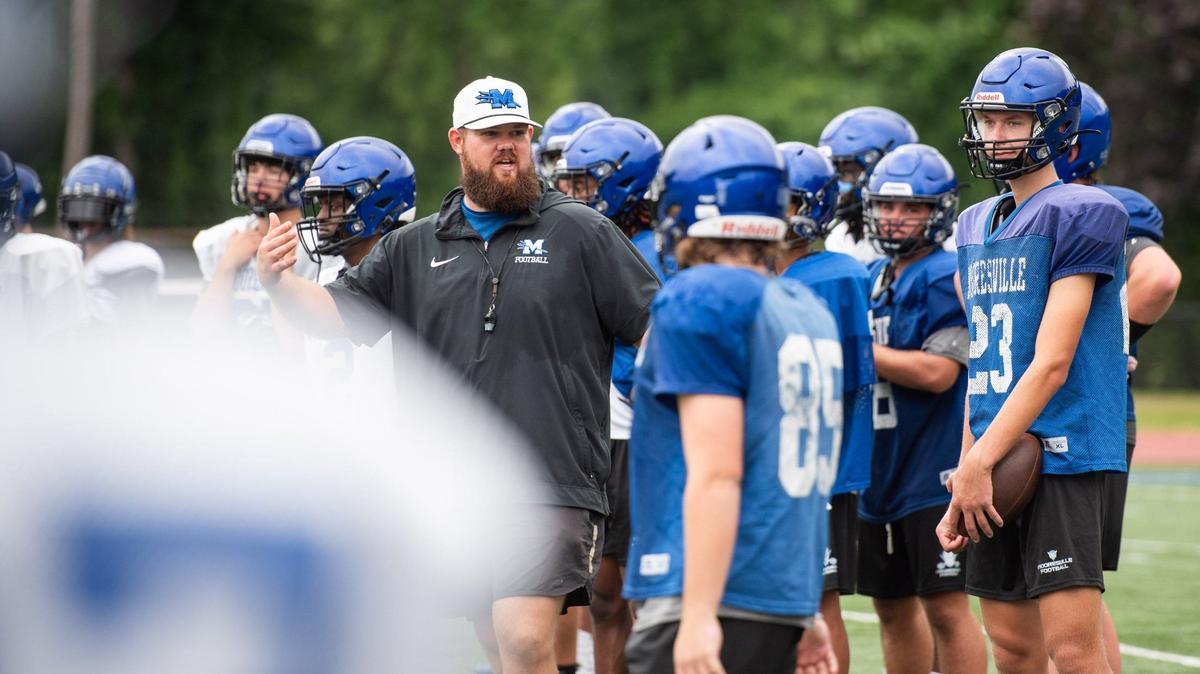 Coach Zach Mayo talking to his team during a morning practice at Coach Joe Popp Stadium on July 25, 2024.