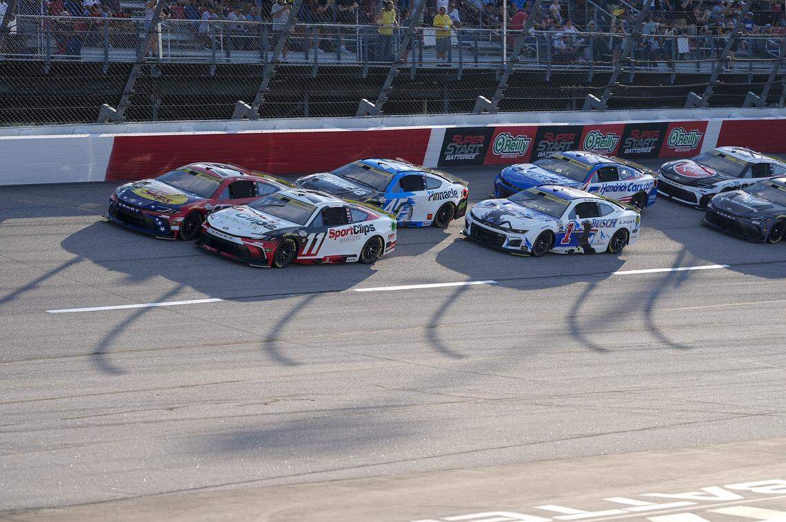 Aug 31, 2025; Darlington, South Carolina, USA; NASCAR Cup Series driver Chase Briscoe (19) and driver Denny Hamlin (11) lead the field to the start during the Cook Out Southern 500 at Darlington Raceway.