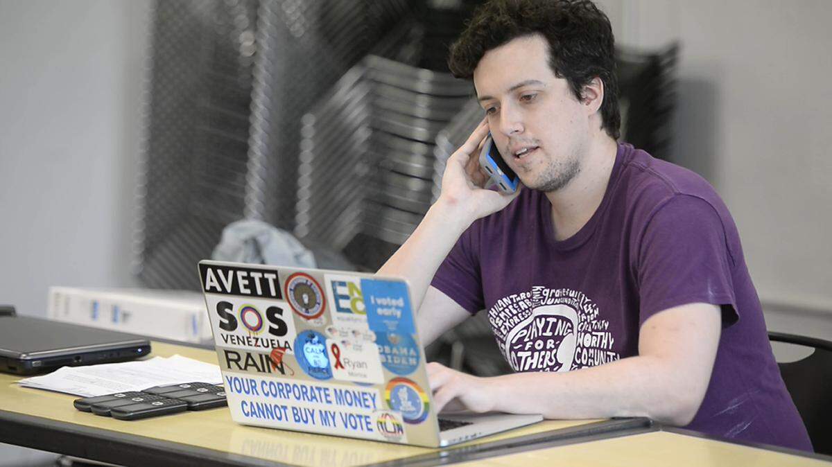 Campaign aide Ryan Morrice conducts a campaign call while at the Gameplan Phone Bank sponsored by NC Sen. Jeff Jackson at Advent Coworking on Thursday, May 24, 2018.