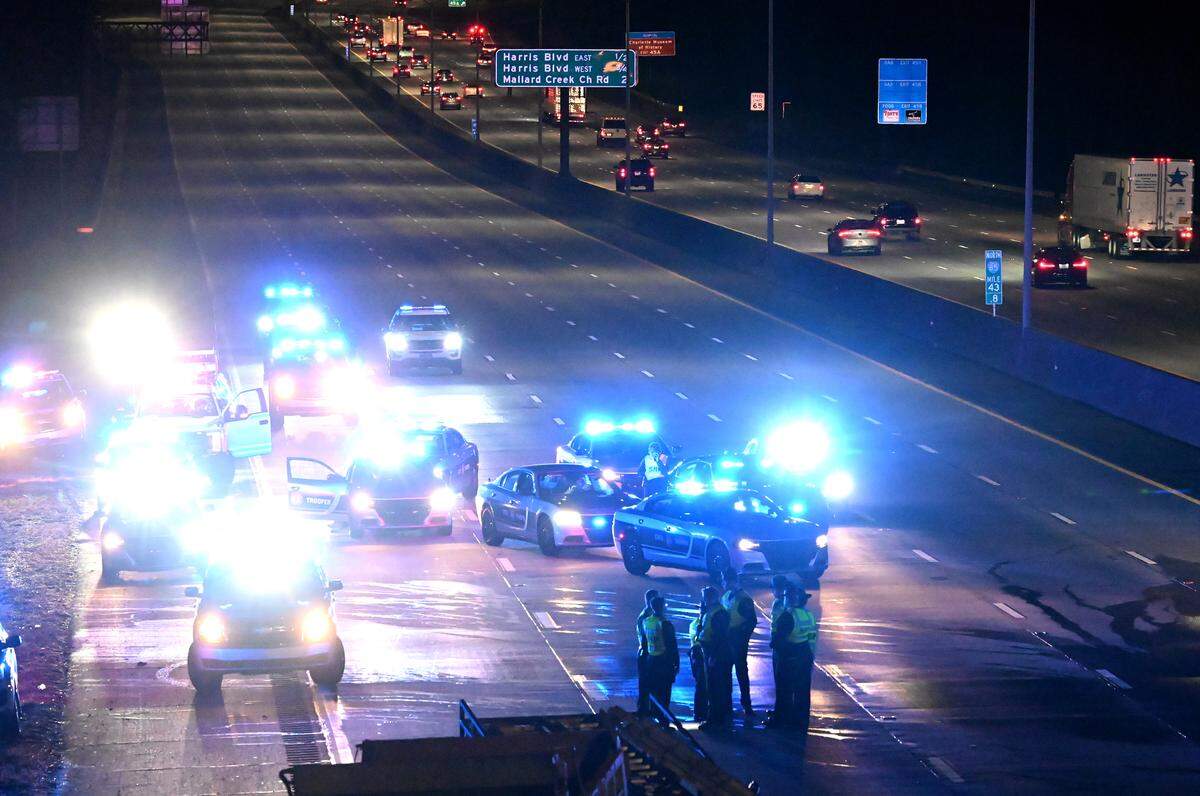 N.C. Highway Patrol officers investigate a fatality along I-85 South near the University Pointe Blvd overpass on Tuesday, January 10, 2023. Four people died in the wreck that closed I-85 South at University City Blvd.