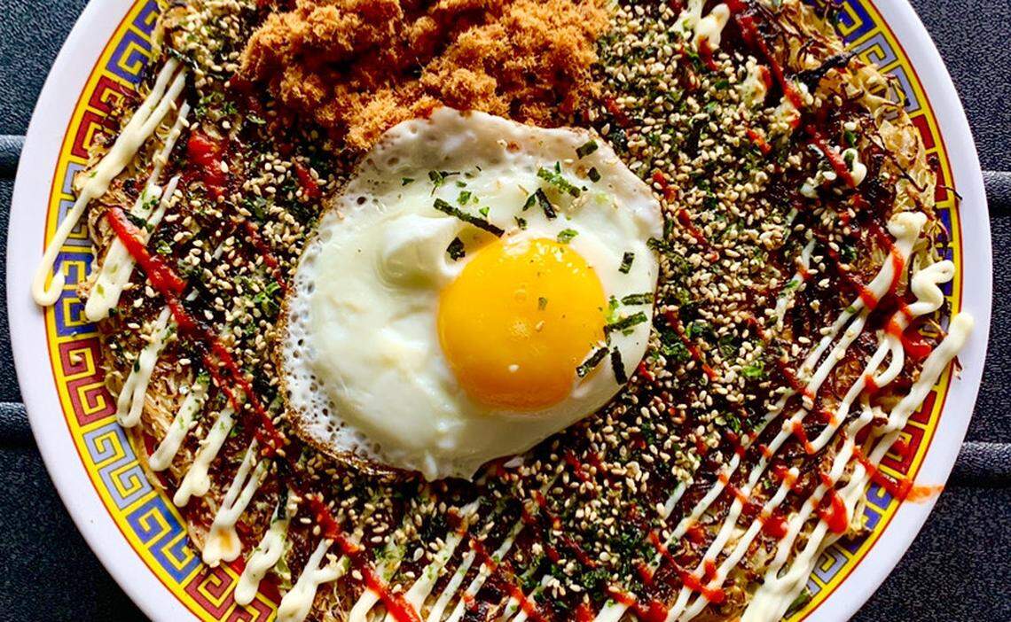 Xiao Bao’s Okonomiyaki, a Japanese cabbage pancake, is $14. Add a sunny side up farm egg or bacon for $2 each, or pork candy or katsuobushi for $1 each. A vegan option is also available.