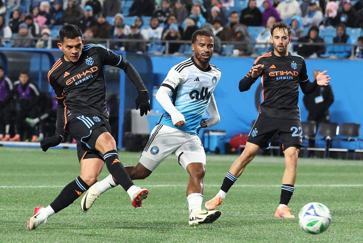 New York City FC striker Alonso Martinez, left, scores a goal against the Charlotte FC right back Nathan Byrne, center, looks on during action at Bank of America Stadium in Charlotte, NC on Tuesday, October 28, 2025.