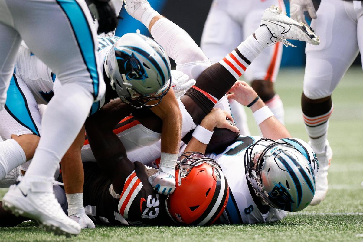 Carolina Panthers quarterback Baker Mayfield (6) is sacked by Cleveland Browns safety Ronnie Harrison Jr. (33) during a game at Bank of America Stadium in Charlotte, N.C., Sunday, Sept. 11, 2022.