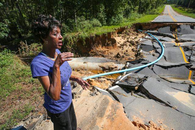 Crystal Simmons, of Wallace, S.C.,  says a friend totaled his car after crashing into this storm-damaged road after Hurricane Florence hit.