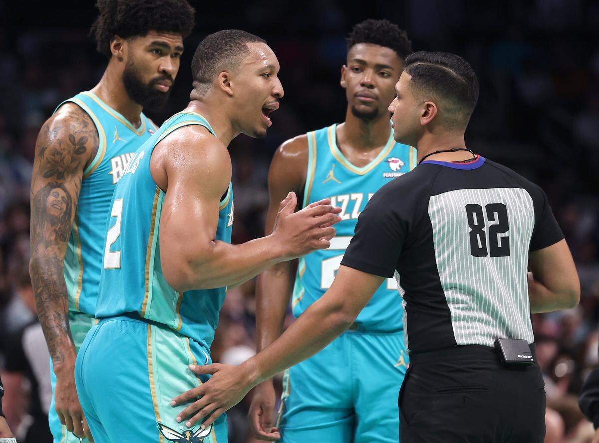 Charlotte Hornets forward Grant Williams stresses a point with umpire Suyash Mehta, right, after being called for a foul during second-half action against the Dallas Mavericks on Tuesday, April 9, 2024 at Spectrum Center in Charlotte, NC. The Mavericks defeated the Hornets 130-104.