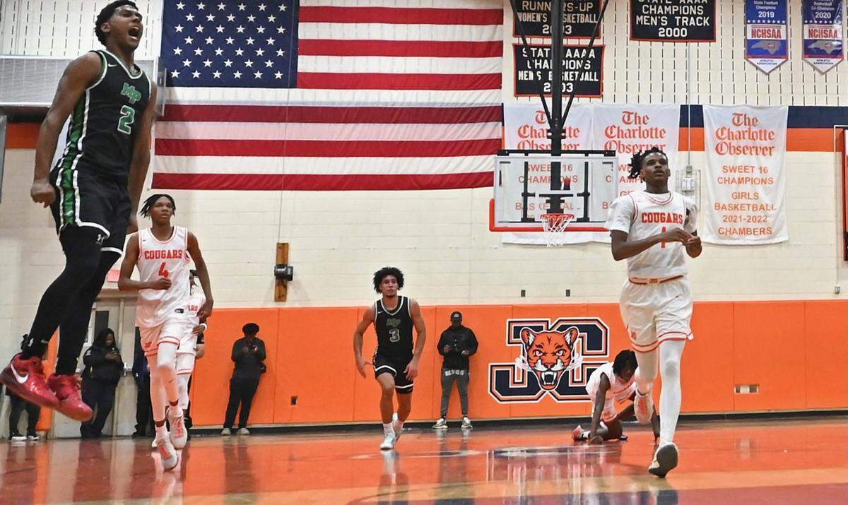 Myers Park’s Sadiq White throws down a two-handed dunk during prep action against Julius Chambers High on Tuesday, November 28, 2023. Myers Park defeated Chambers 63-61.