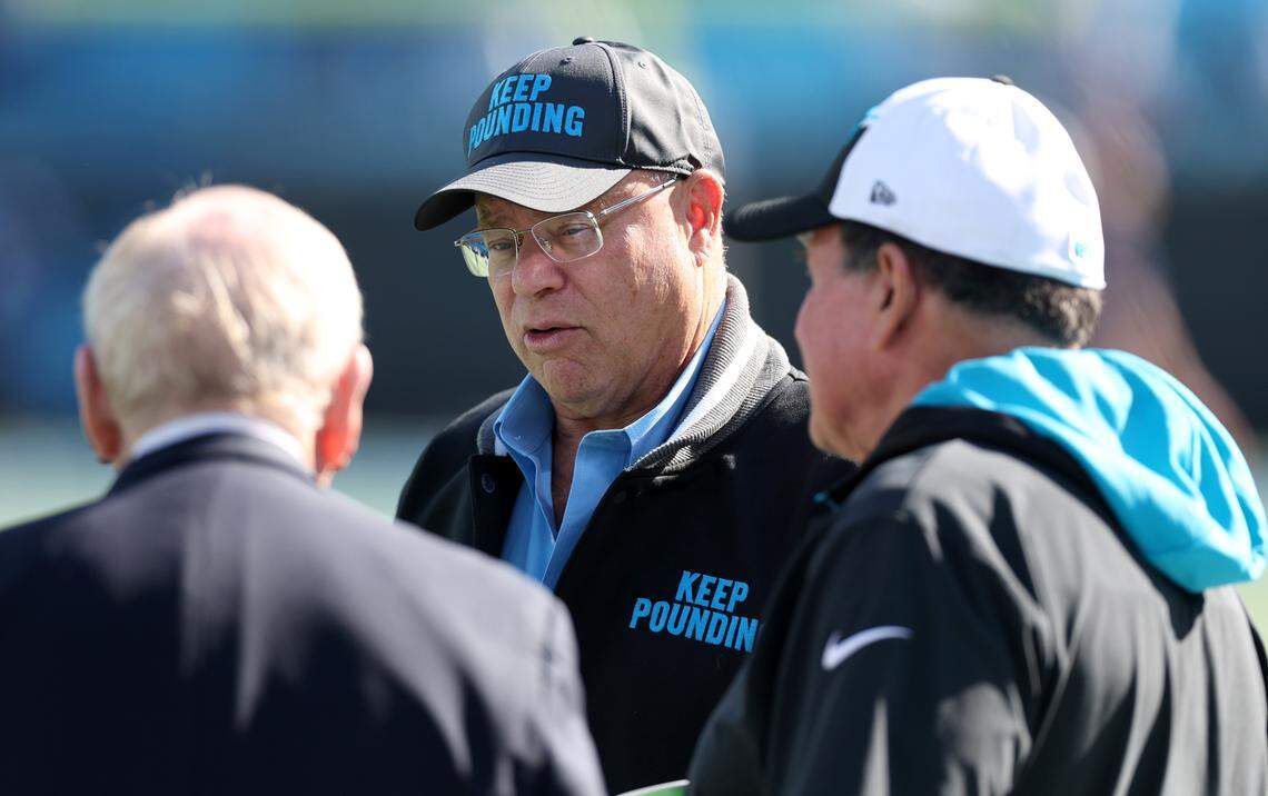 Carolina Panthers owner David Tepper, center, speaks with former general manager Bill Polian, left and senior defensive assistant Dom Capers, right, prior to the team’s game against the Dallas Cowboys on Sunday, November 19, 2023 at Bank of America Stadium.
