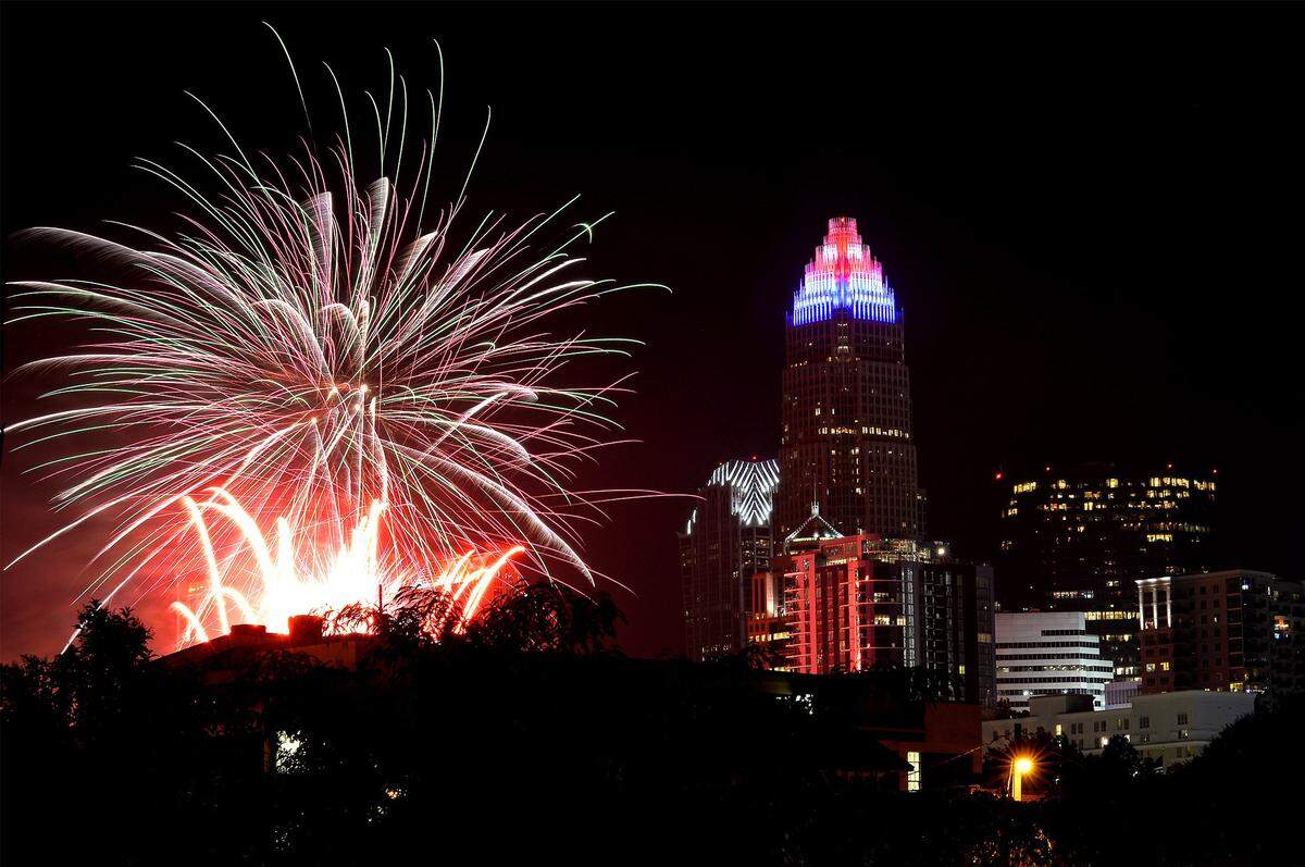 A burst of fireworks at BB&T Ballpark, now Truist Field, light up the Charlotte skyline on July 4, 2019.