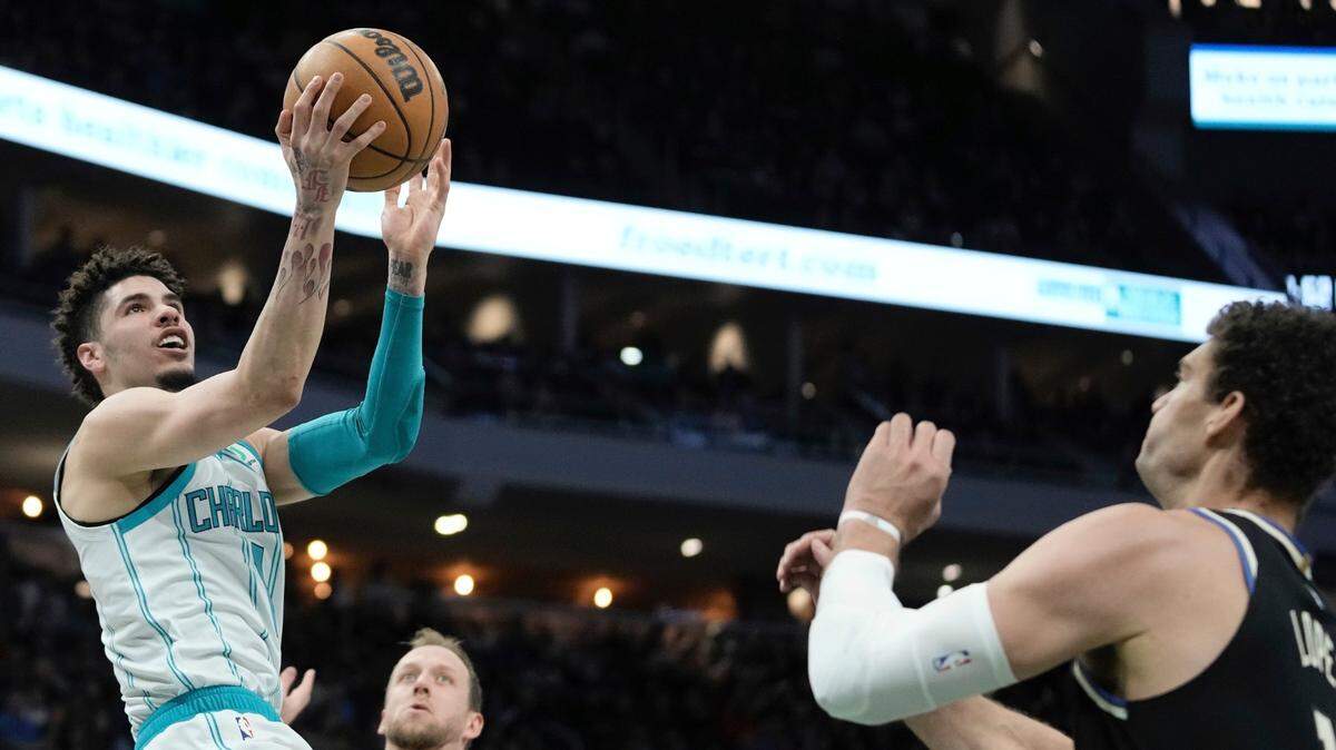 Charlotte Hornets’ LaMelo Ball shoots past Milwaukee Bucks’ Brook Lopez during the first half of an NBA basketball game Tuesday, Jan. 31, 2023, in Milwaukee. (AP Photo/Morry Gash)