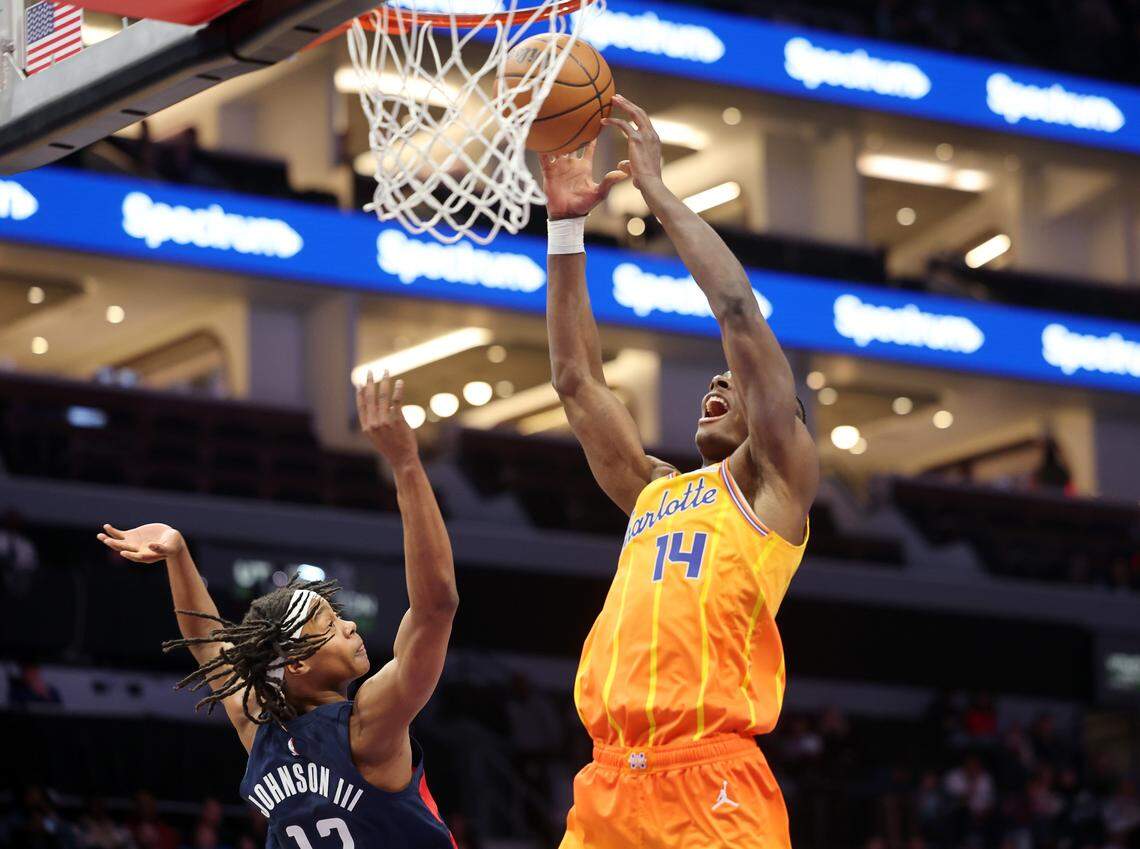 Charlotte Hornets’ Moussa Diabate puts up the shot as Tre Johnson III defends during the game against the Washington Wizards on Saturday, Jan. 24, 2026 at Spectrum Center in Charlotte, North Carolina.
