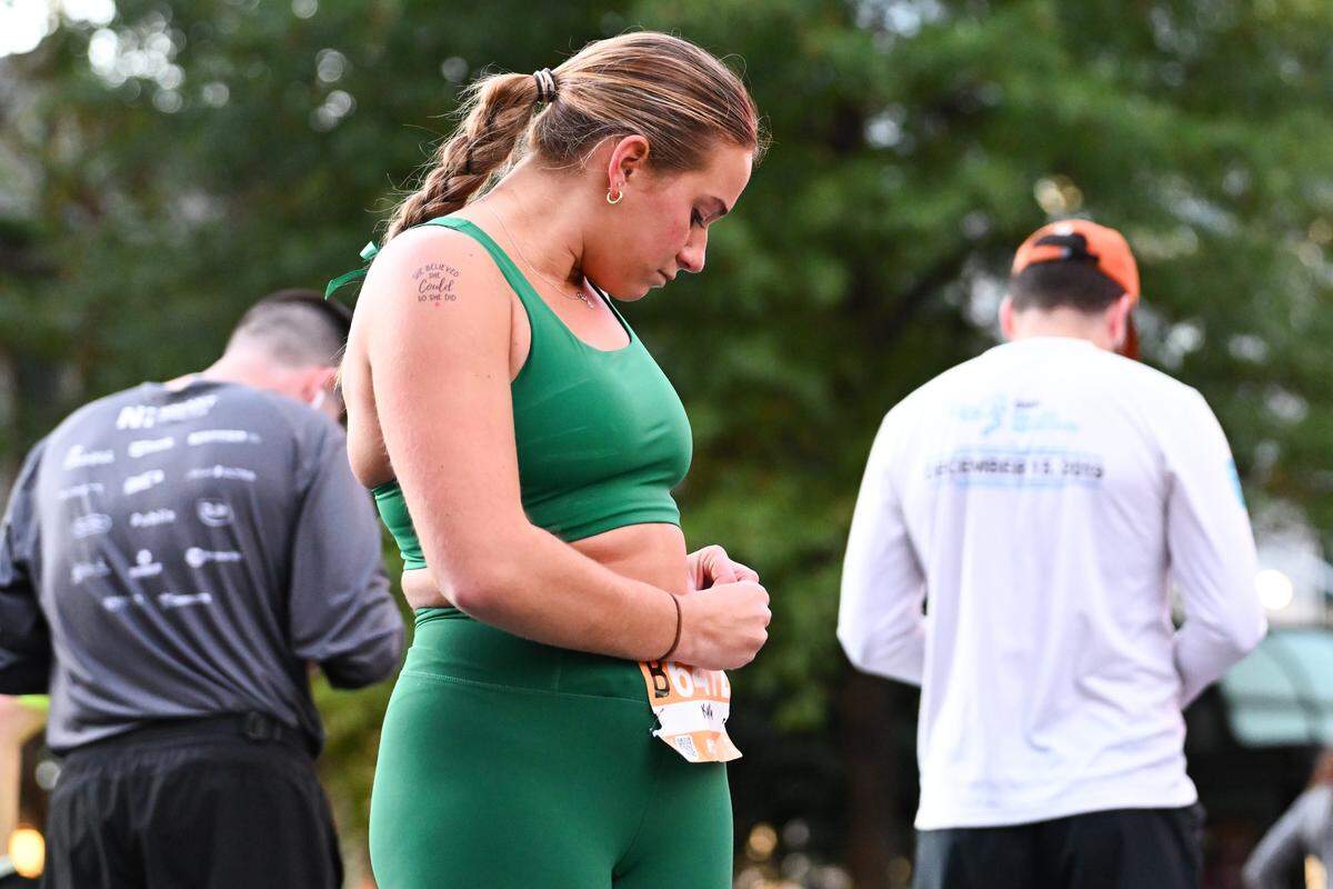 A participant fixes their bib prior to taking part in the 20th annual Novant Health Charlotte Marathon on Saturday, Nov. 16, 2024, in Charlotte