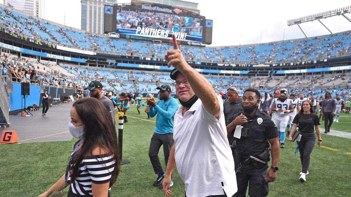 Carolina Panthers owner David Tepper celebrates the team’s victory over the New Orleans Saints as he exits the field at Bank of America Stadium on Sept. 18, 2021.