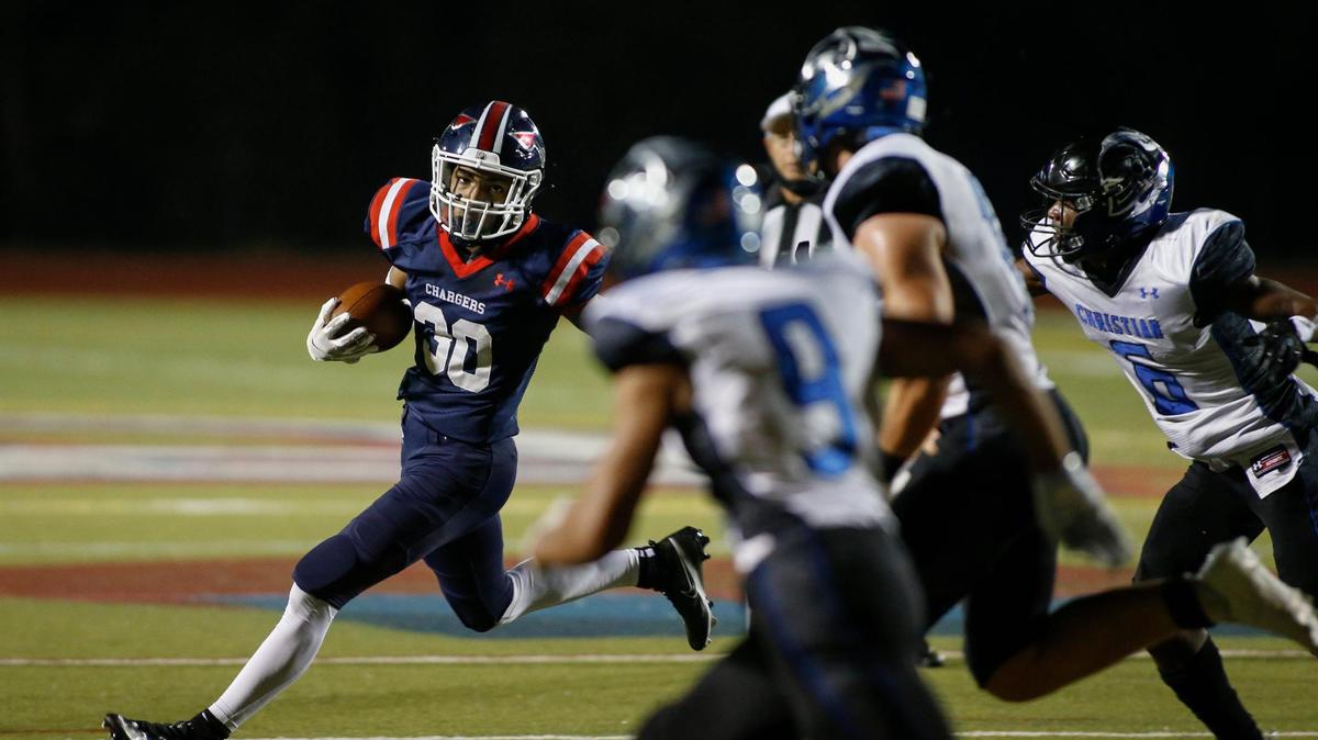 Providence Day receiver Chris Peal, left, runs after a catch against Charlotte in the first half in the Big South 4A championship game in Charlotte, N.C., Friday, Nov. 6, 2020. (Nell Redmond photo)