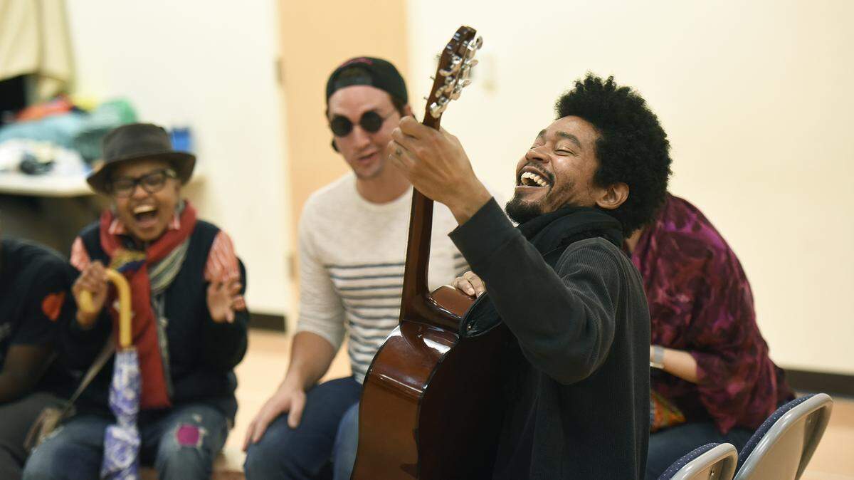 Guitar Man (Jeremy Decarlos, right) plays his song on the dragon bus during a Children’s Theatre of Charlotte rehearsal of the “Last Stop on Market Street.” It’s part of the theater’s Kindness Project, the first of three plays this year and next.