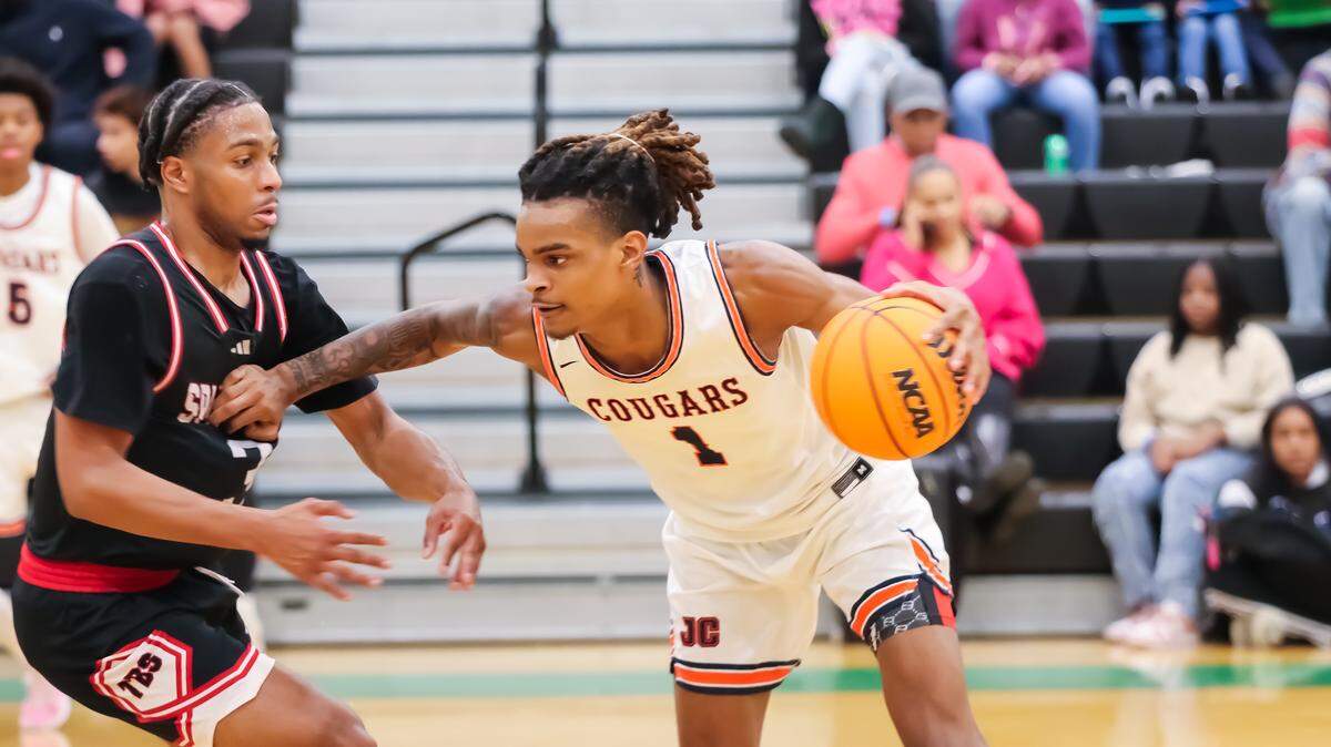 Chambers Markus Kerr drives past Burlington’s defender at the George Lynch Invitational hosted by Phenom Hoops at Myers Park high school on November 23rd
