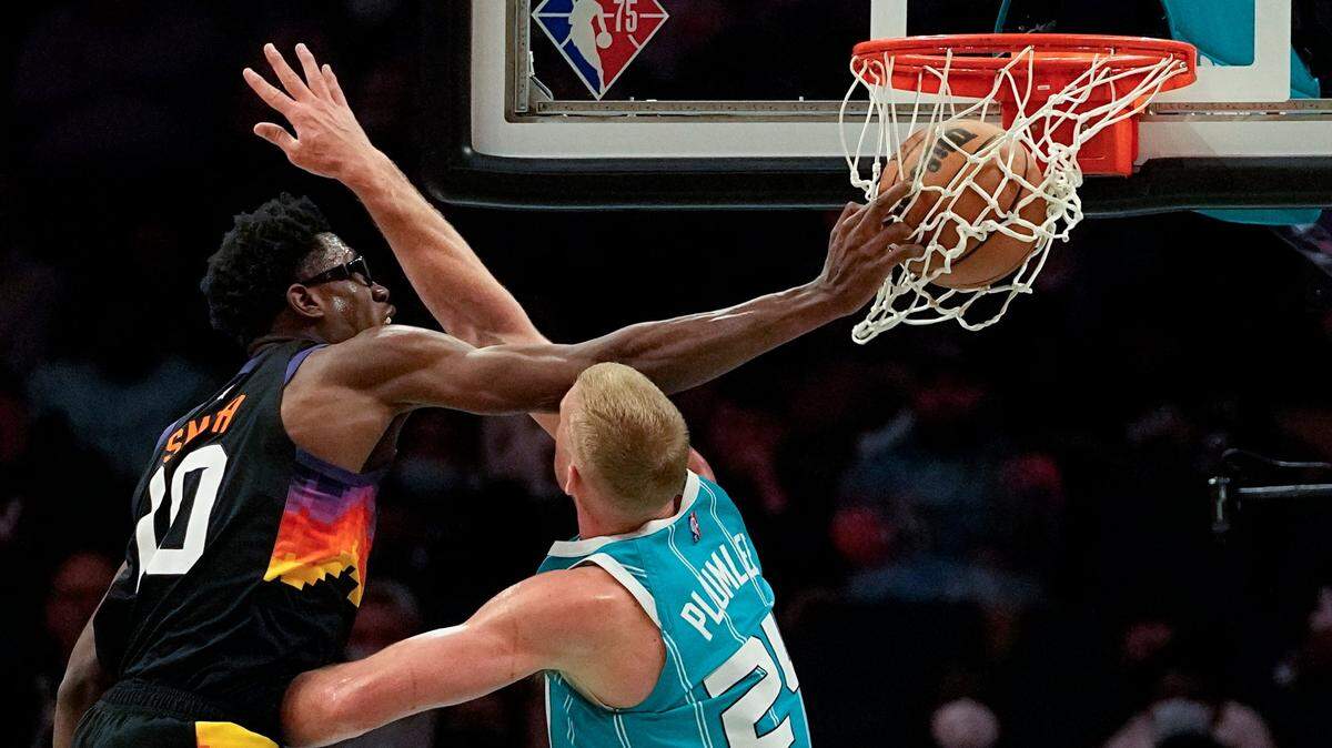 Phoenix Suns forward Jalen Smith dunks over Charlotte Hornets center Mason Plumlee during the second half of an NBA basketball game on Sunday, Jan. 2, 2022, in Charlotte, N.C. Phoenix won, 133-99, as Smith had 19 points and 12 rebounds.